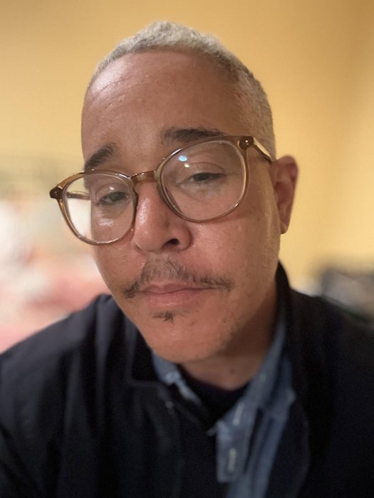 Kumasi a biracial man with glasses